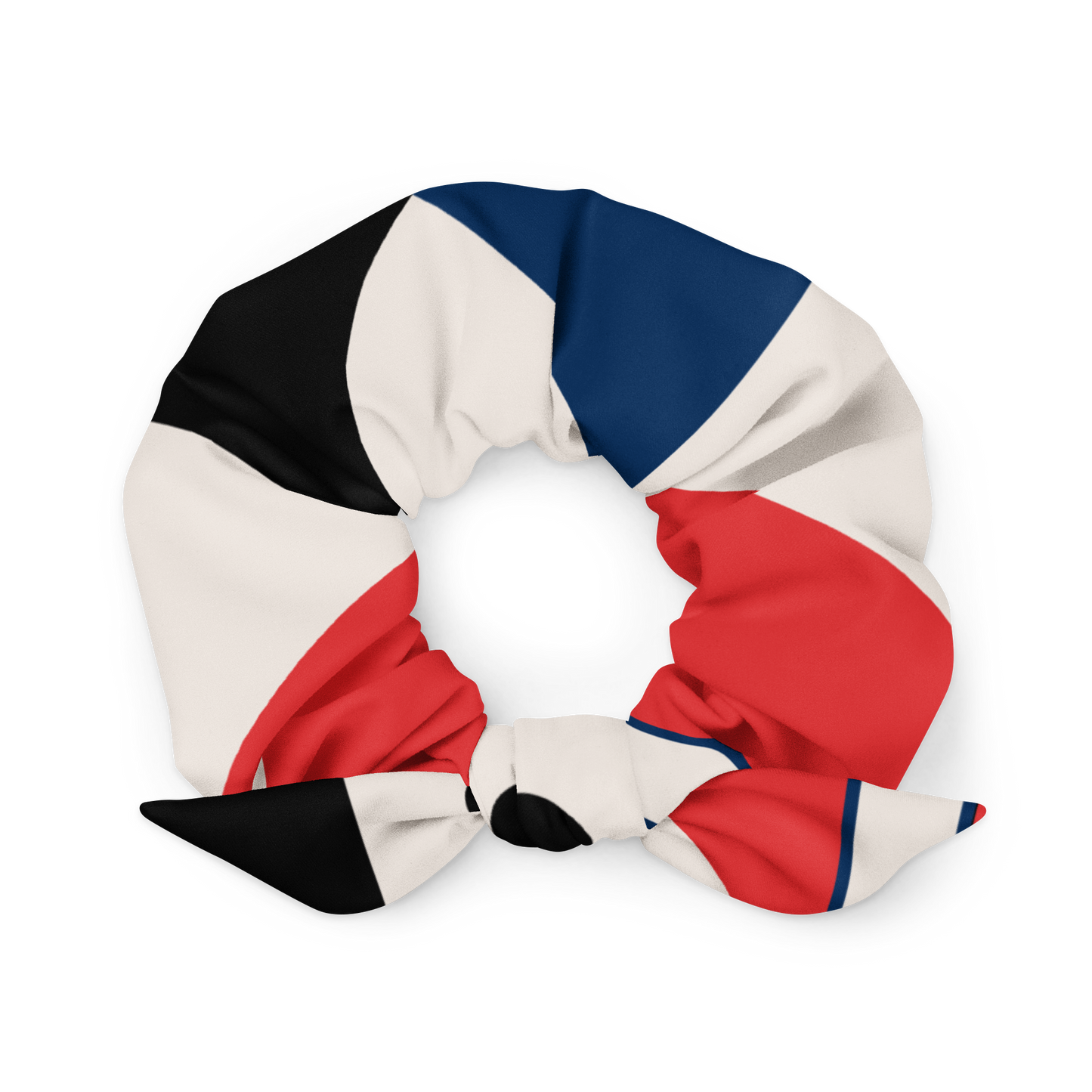 Colorful scrunchie with black, white, blue, and red sections on a white background
