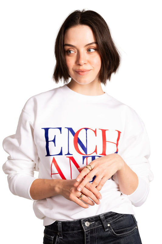 Person wearing a white sweatshirt with colorful text on a plain background