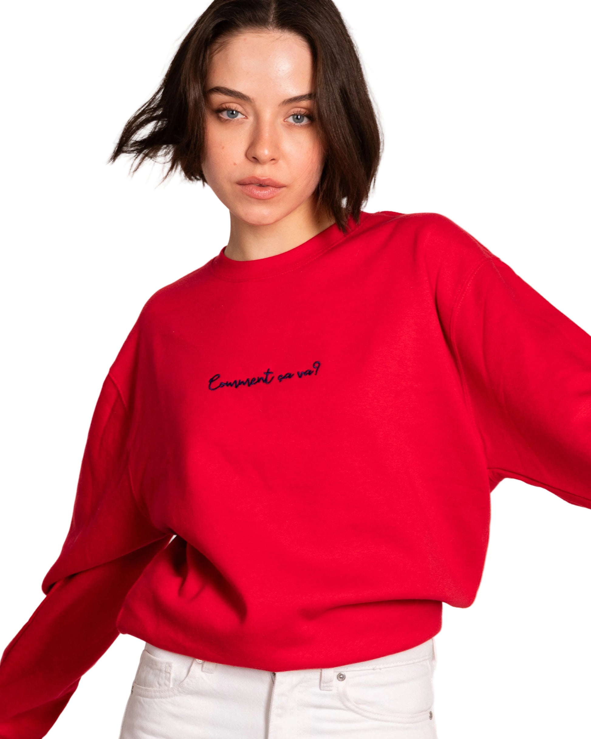 Person wearing a red sweatshirt with text on a plain background
