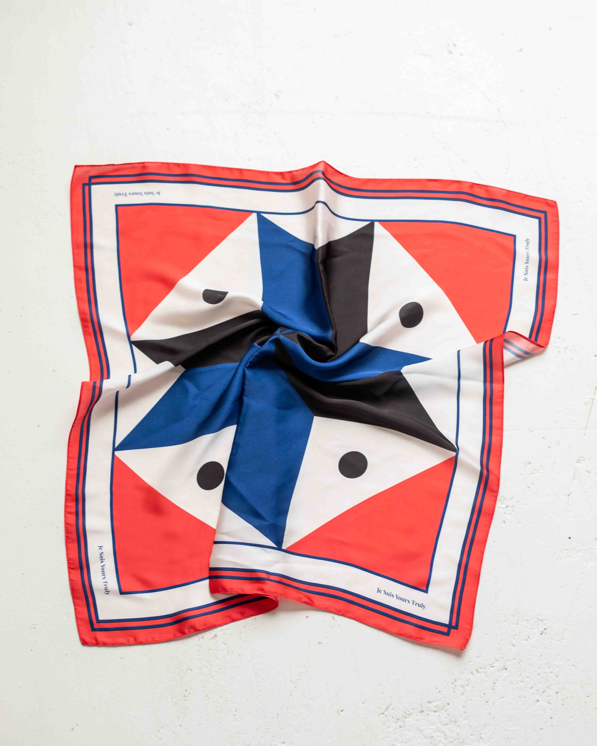 Colorful geometric patterned scarf on a white background
