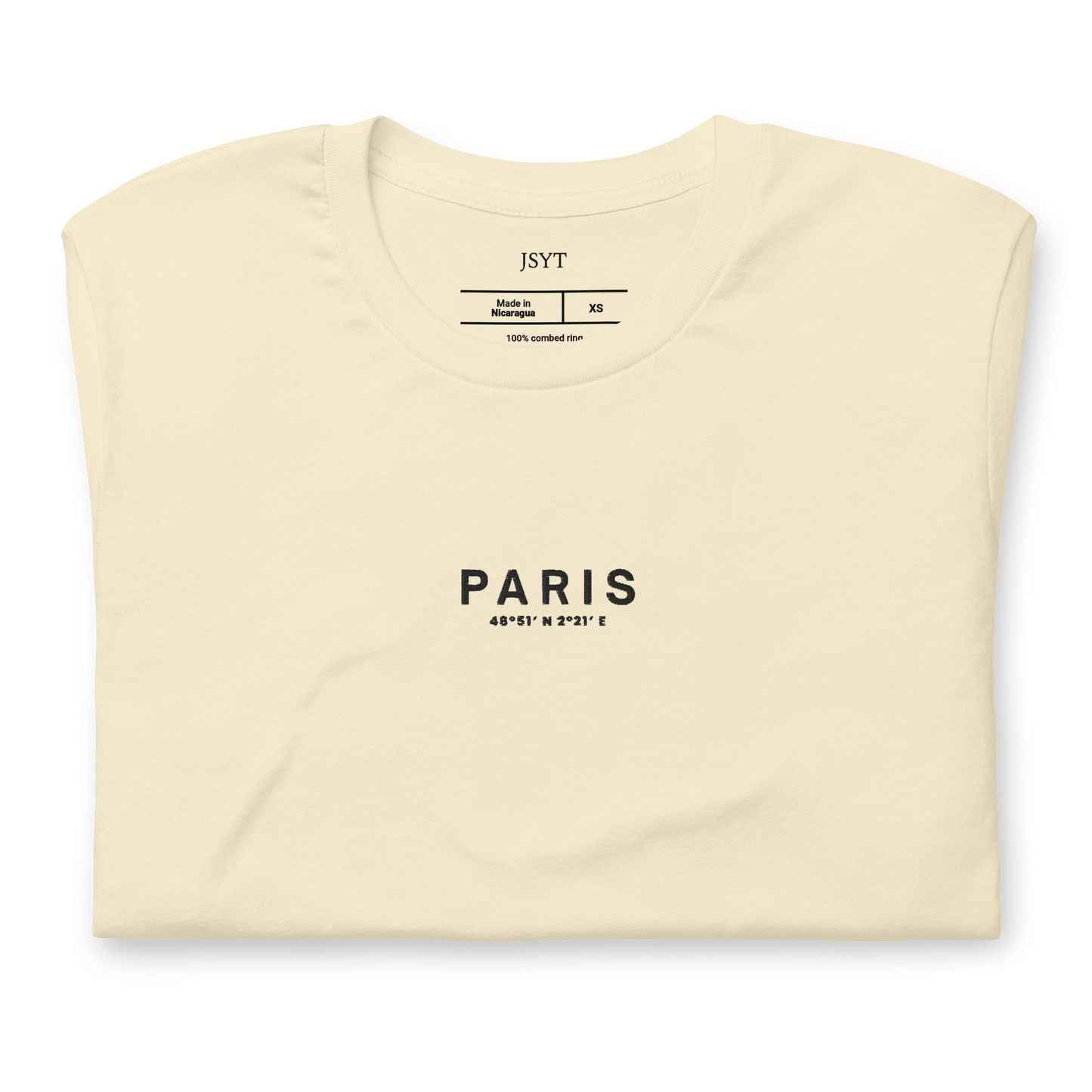 Folded cream-colored t-shirt with 'PARIS' text on a white background